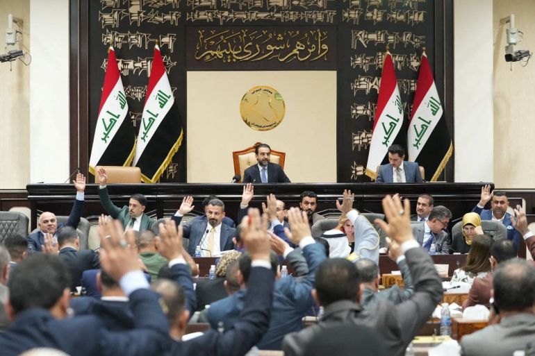 Iraqi lawmakers attend a parliamentary session to vote on the federal budget at the parliament headquarters in Baghdad
