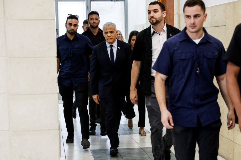 Israeli opposition leader Yair Lapid arrives at the Jerusalem District Court to testify in Prime Minister Benjamin Netanyahu's corruption trial in Jerusalem