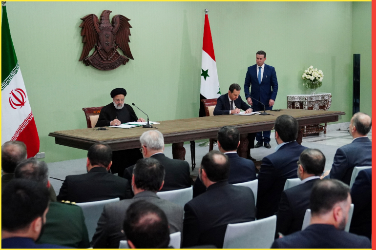 Syria's President Bashar al-Assad and Iranian President Ebrahim Raisi are pictured during the signing of cooperation agreement in Damascus, Syria, in this handout released by SANA on May 3, 2023. SANA/Handout via REUTERS ATTENTION EDITORS - THIS IMAGE WAS PROVIDED BY A THIRD PARTY.