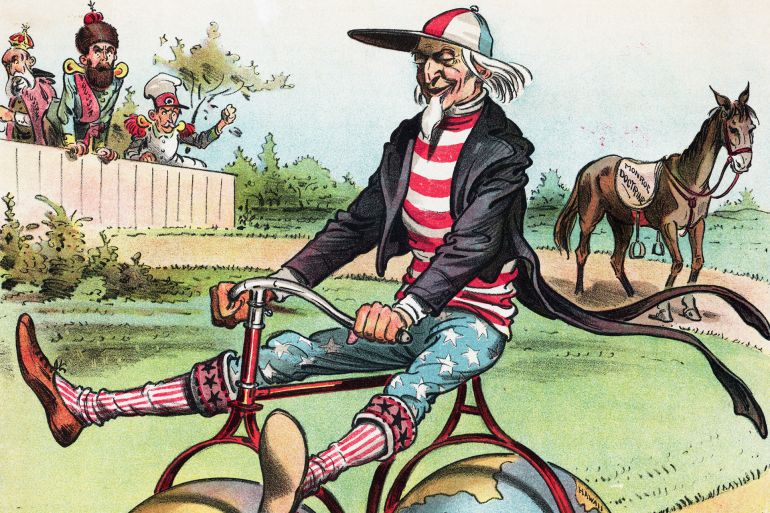 Coasting Political Cartoon by Victor Gillam Political cartoon criticizing American foreign policy, with the title "COASTING," and the original caption "The old horse is too slow for Uncle Sam." Depicts Uncle Sam riding a bicycle with globes labeled "western hemisphere" and "eastern hemisphere" for wheels. He has abandoned his horse, on whose saddle appears, "MONROE DOCTRINE." Color lithograph, 1898. GettyImages-517398148