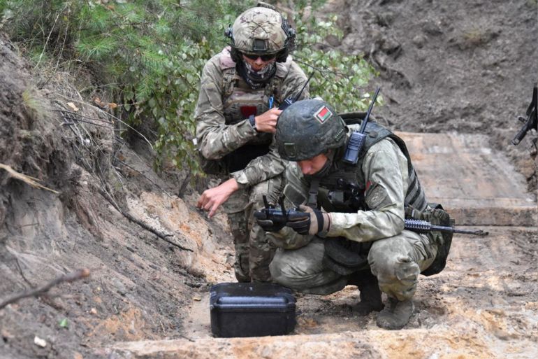 A fighter from Russian Wagner mercenary group and a Belarusian service member take part in a joint training at the Brest military range outside Brest, Belarus, in this still image released July 20, 2023. Belarusian Defence Ministry/Handout via REUTERS ATTENTION EDITORS - THIS IMAGE WAS PROVIDED BY A THIRD PARTY. NO RESALES. NO ARCHIVES. MANDATORY CREDIT.