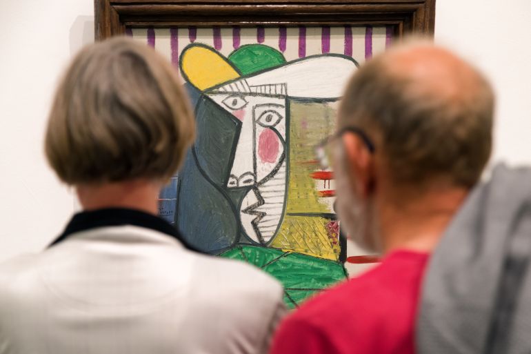 LONDON, UNITED KINGDOM - MAY 12: Visitors looking at Pablo Picasso painting Bust of woman at Tate ...