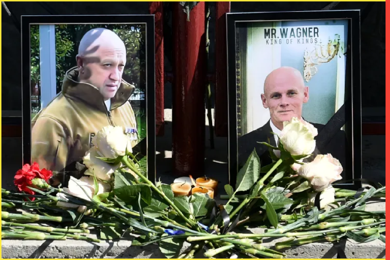Portraits of Yevgeny Prigozhin (L) and Dmitry Utkin (R), a shadowy figure who managed Wagner's operations and allegedly served in Russian military intelligence, are seen at the makeshift memorial in front of the PMC Wagner office in Novosibirsk, on August 24, 2023. - Russian state-run news agencies on August 23, 2023 said that Yevgeny Prigozhin, the head of the Wagner group that led a mutiny against Russia's army in June, was on the list of passengers of a plane that crashed near the village of Kuzhenkino in the Tver region. (Photo by Vladimir NIKOLAYEV / AFP) (AFP)