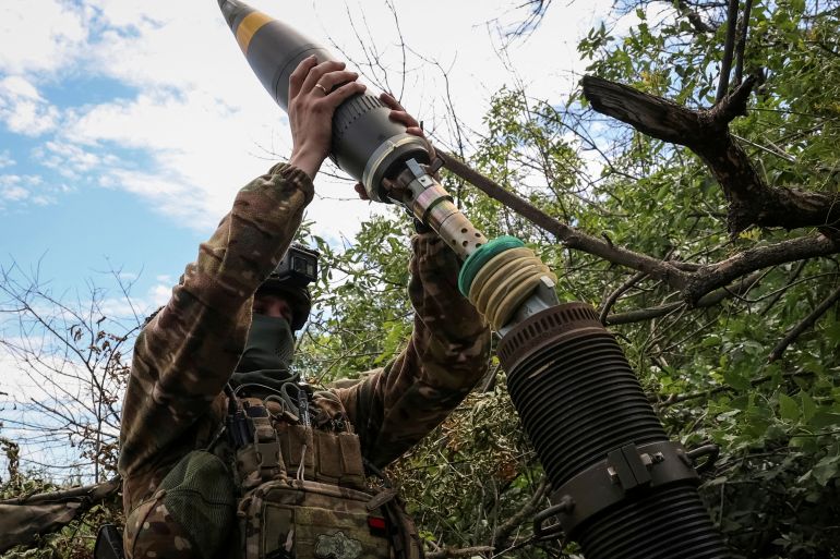 FILE PHOTO: Ukrainian service members fire a mortar at a front line near the city of Bakhmut