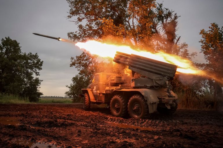 Ukrainian servicemen fire a BM-21 Grad multiple launch rocket system towards Russian troops near a front line in Donetsk region