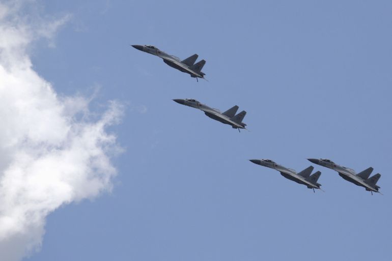FILE PHOTO: J-11B fighter jets of the Chinese Air Force fly in formation during a training session for the upcoming parade marking the 70th anniversary of the end of World War Two, on the outskirts of Beijing, July 2, 2015. Troops from Russia and Mongolia will march together with Chinese forces in a parade in Beijing in September to commemorate the end of World War Two, the government and state media said on Thursday, confirming the first two foreign participants. REUTERS/Jason Lee/File Photo