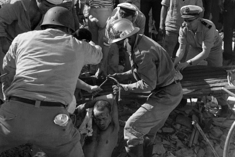 A Muslim survivor is hauled unconsciousness from beneath the ruins of a building in Agadir, Morocco, during rescue work in the earthquake-ravaged city, March 8, 1960. His right arm, which was trapped under tons of fallen masonry, was amputated by a French Naval surgeon, before he was rescued. (AP Photo)