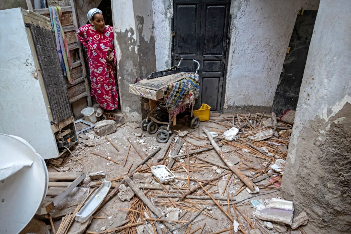 A woman inspects the damage following a 6.8-magnitude quake in Marrakesh on September 9, 2023. - A powerful earthquake that shook Morocco late September 8 killed more than 600 people, interior ministry figures showed, sending terrified residents fleeing their homes in the middle of the night. (Photo by FADEL SENNA / AFP)