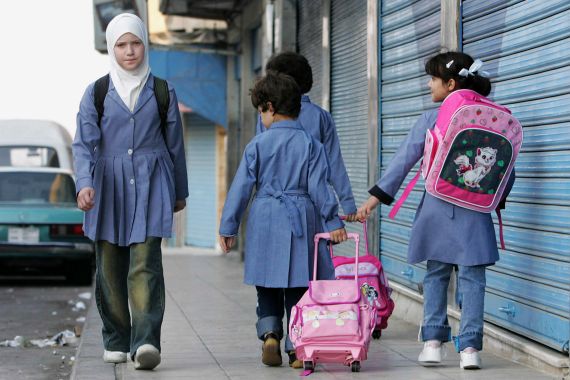 Girls go to school during their first day at a public school in Amman August 19, 2007. REUTERS/Muhammad Hamed (JORDAN)