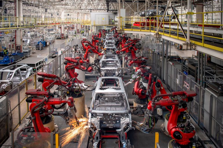 Robotic arms assemble cars in the production line for Leapmotor's electric vehicles at a factory in Jinhua, Zhejiang province, China, April 26, 2023. China Daily via REUTERS ATTENTION EDITORS - THIS PICTURE WAS PROVIDED BY A THIRD PARTY. CHINA OUT. NO COMMERCIAL OR EDITORIAL SALES IN CHINA.