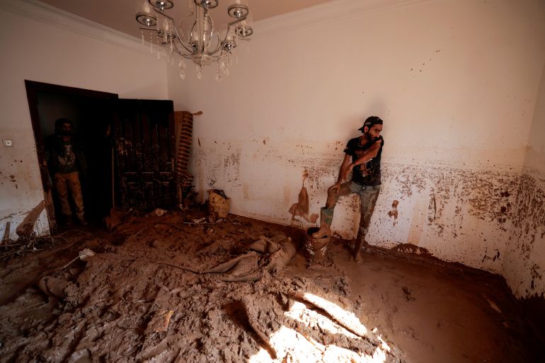 A flood survivor takes a breath while removing mud that invaded his house during a powerful storm and heavy rainfall, in Derna, Libya September 16, 2023. REUTERS/Zohra Bensemra