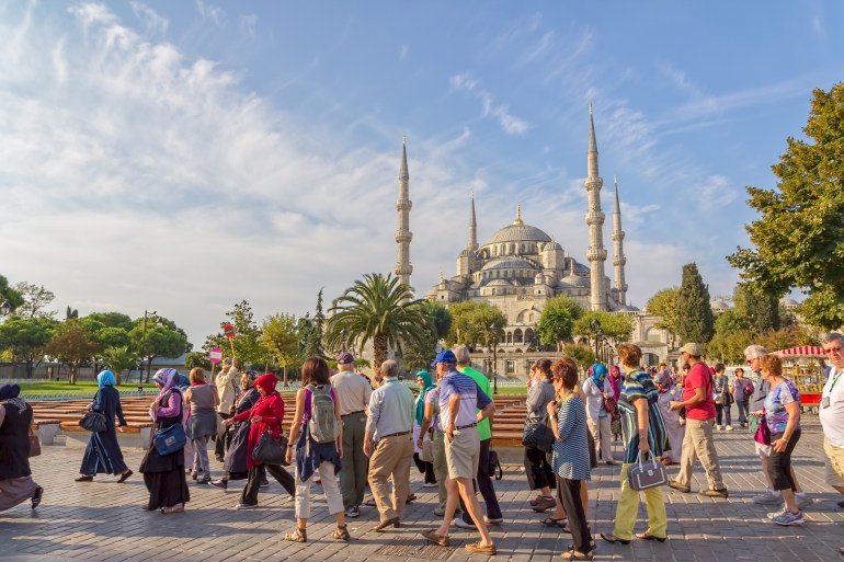 ISTANBUL, TURKEY - SEPTEMBER 27, 2013: Tourist walking around Blue mosque and Sultanahmet park. The biggest mosque in Istanbul of Sultan Ahmed (Ottoman Empire).; Shutterstock ID 188220362; purchase_order:AJA; job:; client:; other: