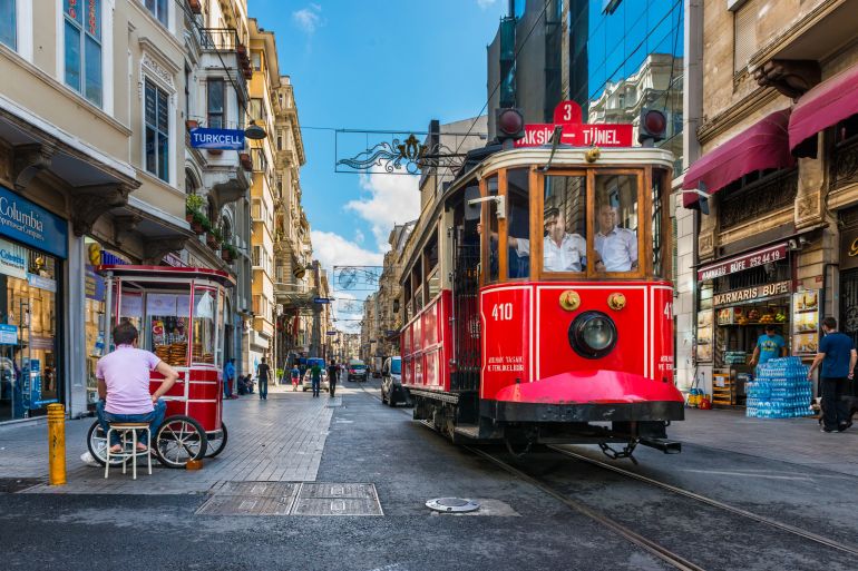 ISTANBUL, TURKEY - JULY 31, 2014: The Taksim-Tunel Nostalgia Tram trundles along the streets of Taksim on July 31, 2014 in Istanbul, Turkey.; Shutterstock ID 232155415; purchase_order:dsc; job:; client:; other: