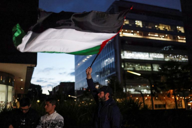 A man carries a Palestinian flag during a demonstration in support of Palestinians, outside the Israeli Embassy, in Bogota, Colombia October 10, 2023. REUTERS/Luisa Gonzalez