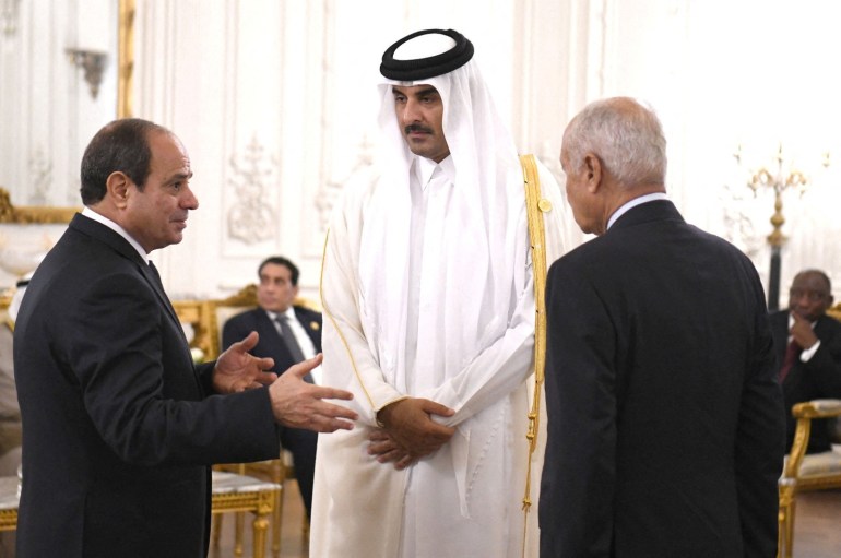 Egyptian President Abdel Fattah al-Sisi talks with Qatari Emir Sheikh Tamim bin Hamad al-Thani and Secretary-General of the Arab League Ahmed Aboul Gheit during the Cairo international summit for peace in the Middle East in the New Administrative Capital (NAC), east of Cairo, Egypt, October 21, 2023 in this handout picture courtesy of the Egyptian Presidency. The Egyptian Presidency/Handout via REUTERS ATTENTION EDITORS - THIS IMAGE HAS BEEN SUPPLIED BY A THIRD PARTY.