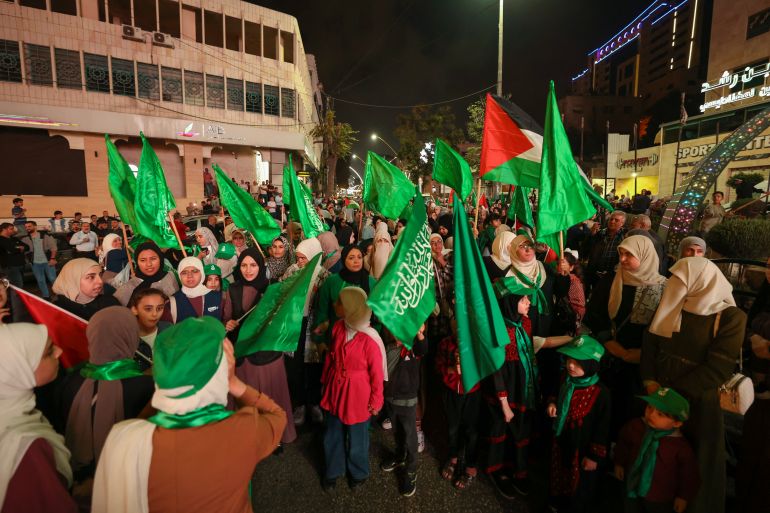 Supporters of the Fatah and Hamas movments lift group and Palestinian flags as they march in Hebron city in the occupied West Bank on October 11, 2023, to protest the Israeli bombardment of the Gaza Strip. - Israel kept up its bombardment of Hamas targets in the Gaza Strip on October 11, as Prime Minister Benjamin Netanyahu and a political rival announced an emergency government for the duration of the conflict that has killed thousands. (Photo by HAZEM BADER / AFP)