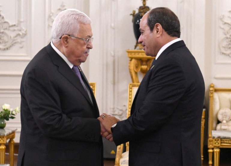 Egyptian President Abdel Fattah al-Sisi greets Palestinian President Mahmoud Abbas during the Cairo international summit for peace in the Middle East in the New Administrative Capital (NAC), east of Cairo, Egypt, October 21, 2023 in this handout picture courtesy of the Egyptian Presidency. The Egyptian Presidency/Handout via REUTERS ATTENTION EDITORS - THIS IMAGE HAS BEEN SUPPLIED BY A THIRD PARTY.