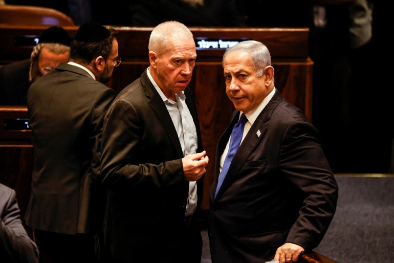 Israeli Defence Minister Yoav Gallant speaks with Prime Minister Benjamin Netanyahu as lawmakers gather at the Knesset plenum to vote on a bill that would limit some Supreme Court power, in Jerusalem July 24, 2023. REUTERS/Amir Cohen