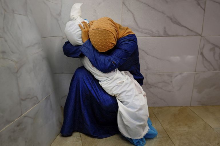In the photo, the woman cradles a child in her arms, balanced on her knee. It is an image that resonates, as ancient as human history. But in a grim inversion of the familiar, we see that the child she holds close is a corpse, wrapped in a shroud. It is a quiet moment of intense grief. The woman wears a headscarf and her head is bowed. We cannot see who she is nor can we learn anything about the child - not even if it is a boy or girl. The child is one of many who have lost their lives on both sides in the Israel-Hamas war. Reuters photographer Mohammad Salem was in Khan Younis in the southern Gaza Strip on Oct. 17 at the Nasser Hospital morgue, where residents were going to search for missing relatives. He saw the woman squatting on the ground in the morgue, sobbing and tightly embracing the child's body. "It was a powerful and a sad moment and I felt the picture sums up the broader sense of what was happening in the Gaza Strip," he said. "People were confused, running from one place to another, anxious to know the fate of their loved ones, and this woman caught my eye as she was holding the body of the little girl and refused to let go." REUTERS/Mohammed Salem SEARCH "SALEM GAZA WOMAN" FOR THIS STORY. SEARCH "WIDER IMAGE" FOR ALL STORIES. TPX IMAGES OF THE DAY