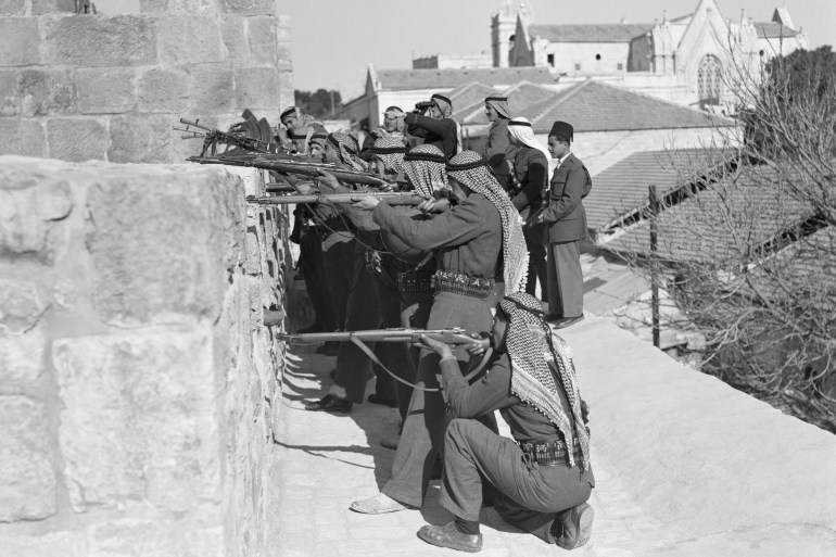 (Original Caption) Jerusalem, Palestine: Arab Sharpshooter And Their Jewish Target. At the top here is an Arab sniping post on the Old City Wall in Jerusalem. The riflemen are shooting towards the Jemin Moshe quarter, which is also called the Montefiore Quarter, inhabited almost exclusively by Jews. A view of the quarter as it appears from the Old City Wall is at bottom. The British have issued a stern ultimatum that warfare in Jerusalem must cease, warning that British troops and heavy weapons will be used against battlers. Yesterday the British used cannons and armored cars to blast Arab positions on the Tel Aviv-Jerusalem highway, backing a Haganah force that was fighting the Arabs.