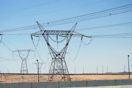 A transmission tower, electricity pylon which is a tall steel lattice structure that used to support overhead high voltage power lines, high voltage electric pillar and sky background in Egypt, selective focus
