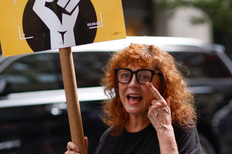 NEW YORK, NEW YORK - AUGUST 17: US Actress Susan Sarandon holds a banner as she joins WGA and SAG-AFTRA members hold a picket as they strike over contract negotiation at Netflix and Warner Bros. Discovery offices in New York on August 17, 2023. (Photo by Kena Betancur/VIEWpress via Getty Images)