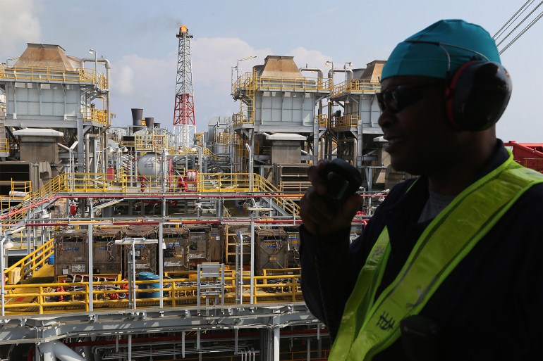 An employee communicates by radio aboard the Agbami floating oil production, storage and offloading vessel (FPSO), operated by Chevron Corp., in the Agbami deepwater oilfield in the Niger Delta, Nigeria, on Wednesday, Dec. 2, 2015. Nigeria plans to review agreements for deep offshore oil production to seek more favorable terms in line with the latest industry standards, state-owned Nigerian National Petroleum Corp. said. Photographer: George Osodi/Bloomberg via Getty Images