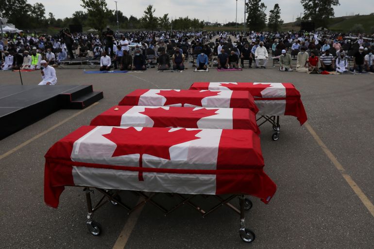 Flag-wrapped coffins are seen outside the Islamic Centre of Southwest Ontario, during a funeral of the Afzaal family that was killed in what police describe as a hate-motivated attack, in London, Ontario, Canada June 12, 2021. REUTERS/Carlos Osorio