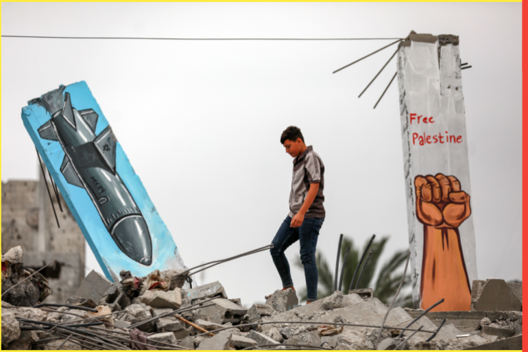 A Palestinian boy stands next to a graffiti mural inside a house destroyed in an Israeli strike in the recent Gaza-Israel fighting, in Deir Al-Balah, central Gaza Strip June 8, 2023.