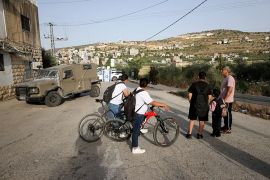 Students are prevented from going to school as Israeli settlers block entry and exit roads to al-Lubban ash-Sharqiya, the home village of Ayman Nobani and his brothers, in June 2023 [Issam Rimawi/Anadolu Agency via Getty Images]