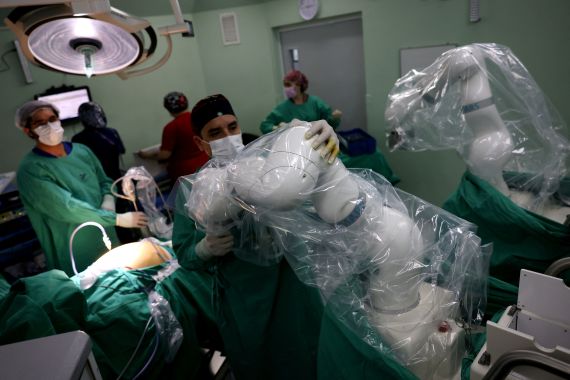 A surgeon prepares magnetic surgical robot arms, new technology instruments that work with magnetic fields, during an operation at a public hospital, in Santiago, Chile, December 4, 2023. REUTERS/Ivan Alvarado