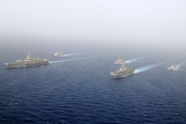 U.S. Navy ships of the Kearsarge Amphibious Ready Group and the Enterprise Carrier Strike Group are seen underway in close formation in the Red Sea in this February 16, 2011 handout photo provided by the U.S. Navy. The United States is moving warships and aircraft, including the USS Enterprise aircraft carrier (L) and USS Kearsarge amphibious assault ship (2nd R), into the Mediterranean Sea near Libya, according to U.S. officials. REUTERS/U.S. Navy/Mass Communication Specialist 3rd Class Scott Pittman/Handout (RED SEA - Tags: MILITARY POLITICS) FOR EDITORIAL USE ONLY. NOT FOR SALE FOR MARKETING OR ADVERTISING CAMPAIGNS. THIS IMAGE HAS BEEN SUPPLIED BY A THIRD PARTY. IT IS DISTRIBUTED, EXACTLY AS RECEIVED BY REUTERS, AS A SERVICE TO CLIENTS