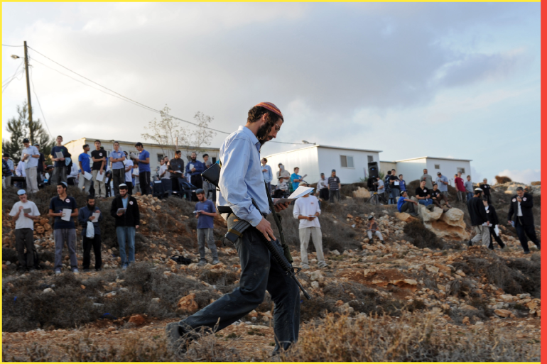 An Israeli settler carries an M-16 gun during a protest in the illegal Jewish settlement Givat Asaf in the West Bank, Givat Asaf Settlement - 27 Oct 2011
