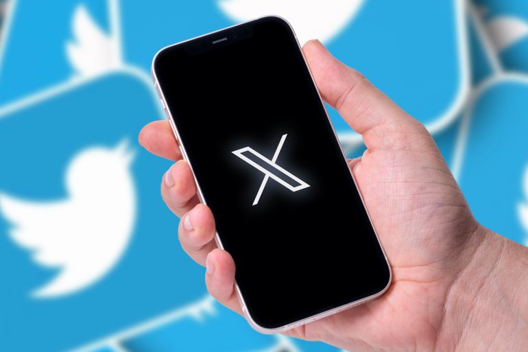 Antalya, Turkey - July 24, 2023: Twitter X logo on smartphone and Twitter logo in background