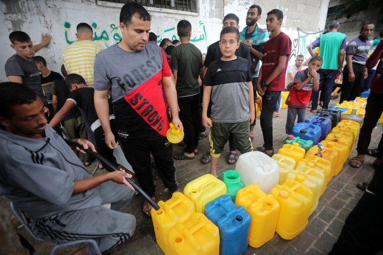Palestinians stan next plastic jerrycans at a water filling point, in Rafah in the southern Gaza Strip on October 28, 2023..Israeli strike continuing on Gaza amidst shortage of medical supplies, water And power Off, but the Israeli airstrikes have caused substantial damage to the infrastructure on the Palestinian side.