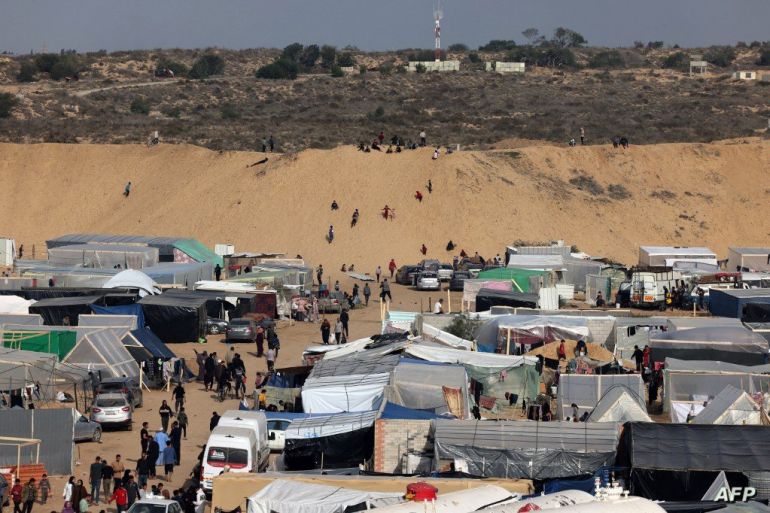 Displaced Palestinians who fled Khan Yunis in the southern Gaza Strip set up camp in Rafah further south near the border with Egypt, on December 7, 2023, amid continuing battles between Israel and the Palestinian militant group Hamas. Heavy urban combat raged in and around Gaza's biggest cities on December 7 as the bloodiest ever war between Israel and Palestinian militant group Hamas entered its third month since the October 7 attacks. (Photo by MOHAMMED ABED / AFP)
