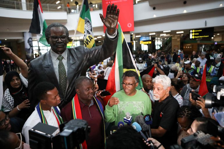 Advocate Tembeka Ngcukaitobi (C), a member of the South African legal team, talks to journalists after landing back in South Africa after representing the country in a two-day hearing against Isreal at the International Court of Justice (ICJ), at the OR Tambo International Airport in Ekurhuleni, South Africa, on January 14, 2024. South Africa on January 11, 2024 accused Israel of breaching the UN Genocide Convention, saying that even the deadly October 7 Hamas attack could not justify such alleged actions, as it opened a case at the top UN court. Pretoria has lodged an urgent appeal to the International Court of Justice (ICJ) to force Israel to "immediately suspend" its military operations in Gaza. (Photo by Alaister Russell / AFP)