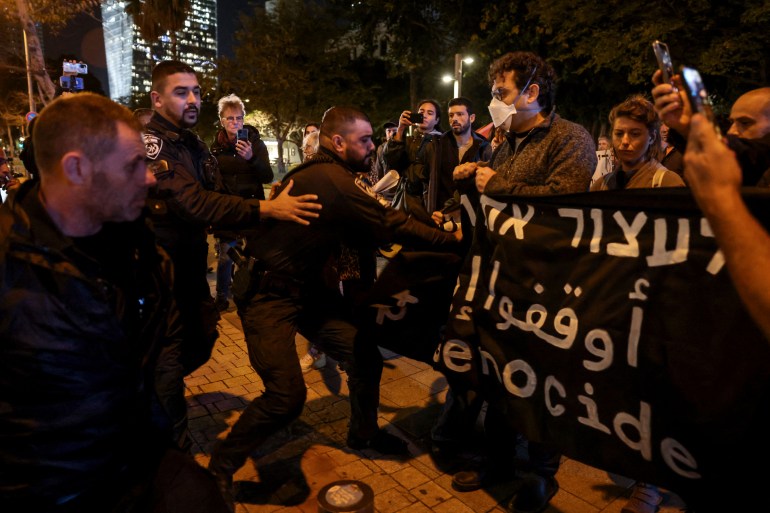 Police disperse a rally by Israeli anti-war and anti-government demonstrators in Tel Aviv, on January 16, 2024, amid the ongoing conflict between Israel and the militant Hamas group in Gaza. (Photo by AHMAD GHARABLI / AFP)