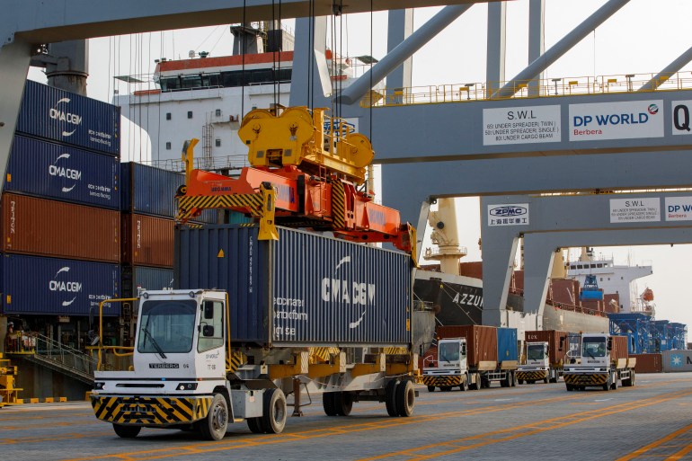 Shipping containers are loaded and off-loaded onto the vessel Okee August at Berbera Port on August 31, 2021. Dubai-based port operator DP World and the Government of Somaliland, opened a container terminal at Berbera Port in June 2021. (Photo by Ed RAM / AFP)