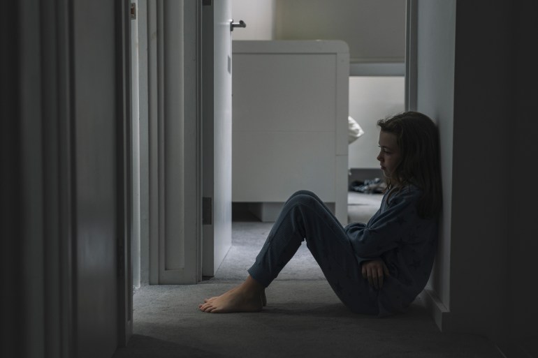 Little girl sitting on landing floor - negative emotions
