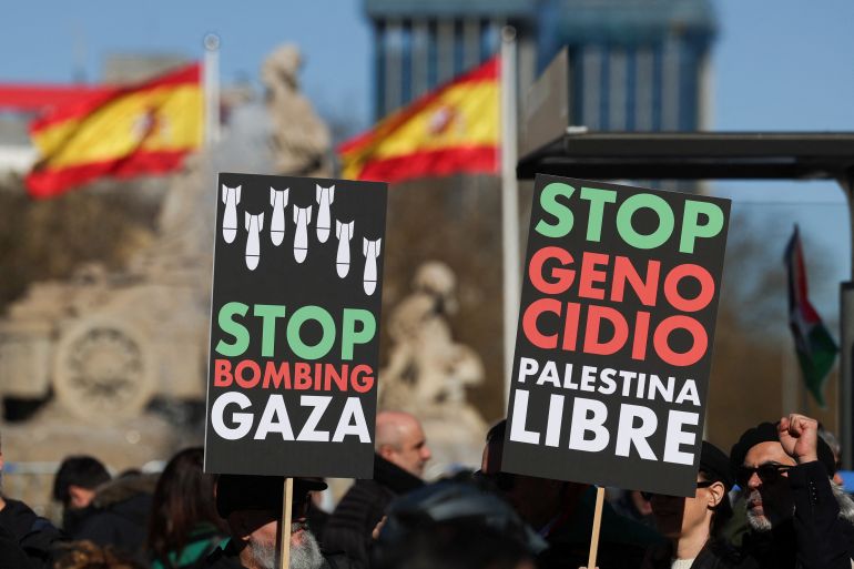 People hold anti-war placards during a protest to call for a ceasefire in Gaza to mark 100 days since the start of the conflict between Israel and the Palestinian Islamist group Hamas, in Madrid, Spain, January 20, 2024. REUTERS/Isabel Infantes