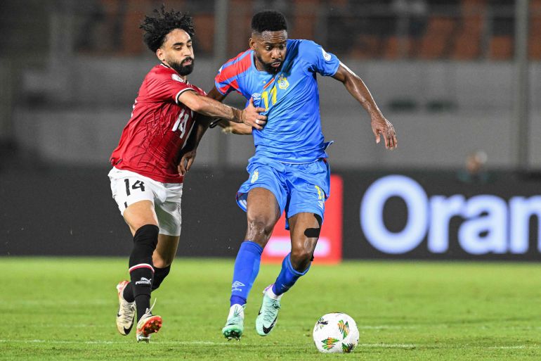 Egypt's midfielder #14 Marwan Attia (L) fights for the ball with DR Congo's forward #11 Silas during the Africa Cup of Nations (CAN) 2024 round of 16 football match between Egypt and DR Congo at the Stade Laurent Pokou in San Pedro on January 28, 2024. (Photo by SIA KAMBOU / AFP)