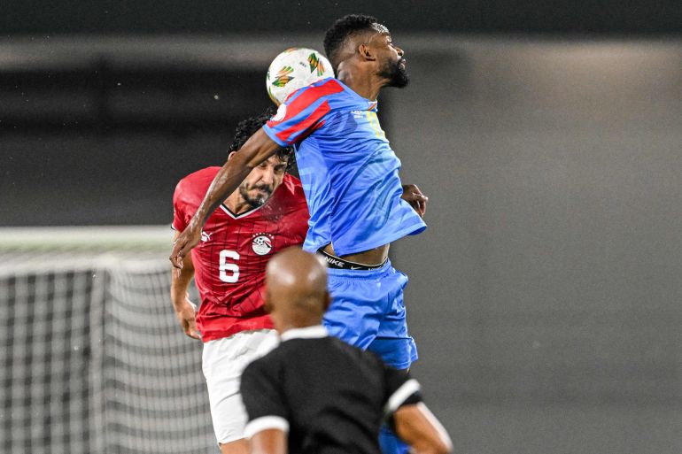 Egypt's defender #6 Ahmed Hegazy (L) fights for the ball with DR Congo's forward #17 Cedric Bakambu during the Africa Cup of Nations (CAN) 2024 round of 16 football match between Egypt and DR Congo at the Stade Laurent Pokou in San Pedro on January 28, 2024. (Photo by SIA KAMBOU / AFP)