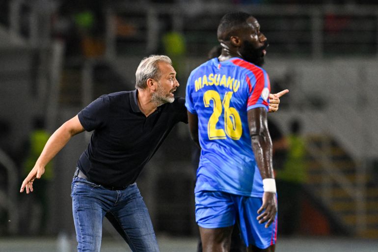 DR Congo's French head coach Sebastien Desabre (L) reacts next to DR Congo's defender #26 Arthur Masuaku during the Africa Cup of Nations (CAN) 2024 round of 16 football match between Egypt and DR Congo at the Stade Laurent Pokou in San Pedro on January 28, 2024. (Photo by SIA KAMBOU / AFP)