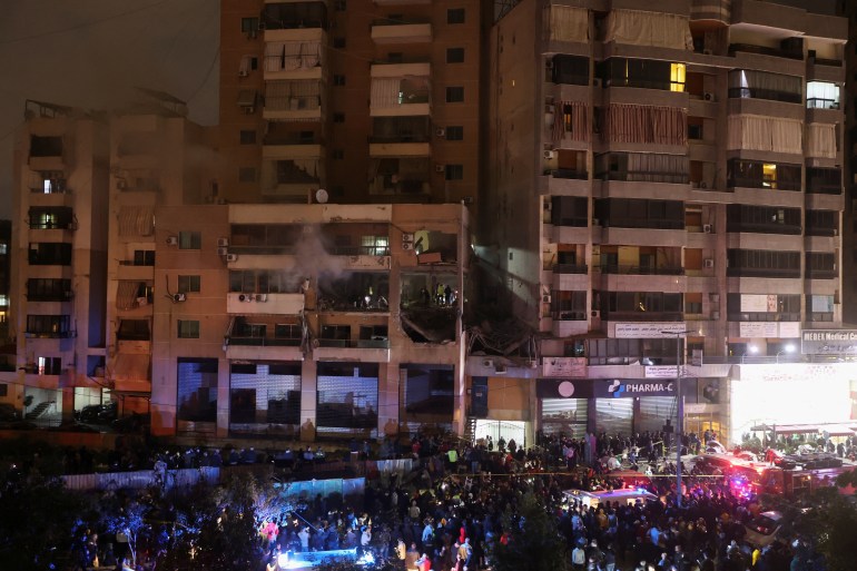 People gather near a damaged site following an explosion at the Beirut suburb of Dahiyeh, Lebanon January 2, 2024. REUTERS/Mohamed Azakir