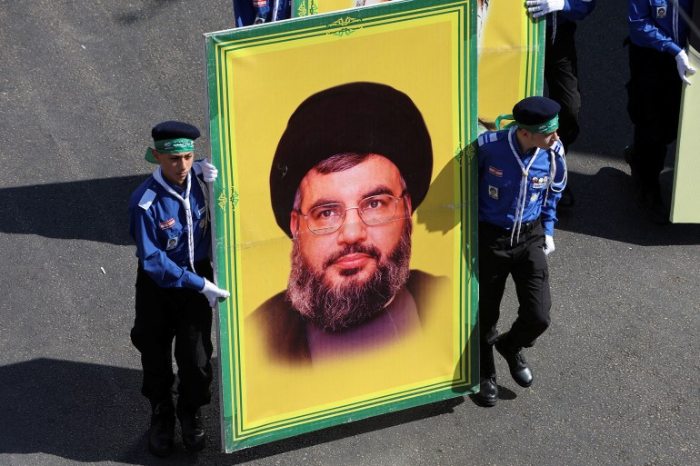 Lebanon's Imam al-Mahdi Scouts carry a picture of Lebanon's Hezbollah leader Sayyed Hassan Nasrallah as they march during a religious procession to mark Ashura in Beirut's suburbs, Lebanon August 9, 2022. REUTERS/Aziz Taher