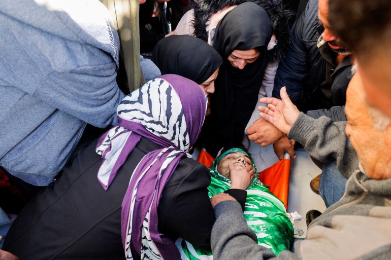 SENSITIVE MATERIAL. THIS IMAGE MAY OFFEND OR DISTURB Mourners react near the body of Palestinian Osaid Bani Odeh, who was killed in an Israeli raid, during his funeral in Tamon, near Tubas in the Israeli-occupied West Bank January 4, 2024. REUTERS/Raneen Sawafta