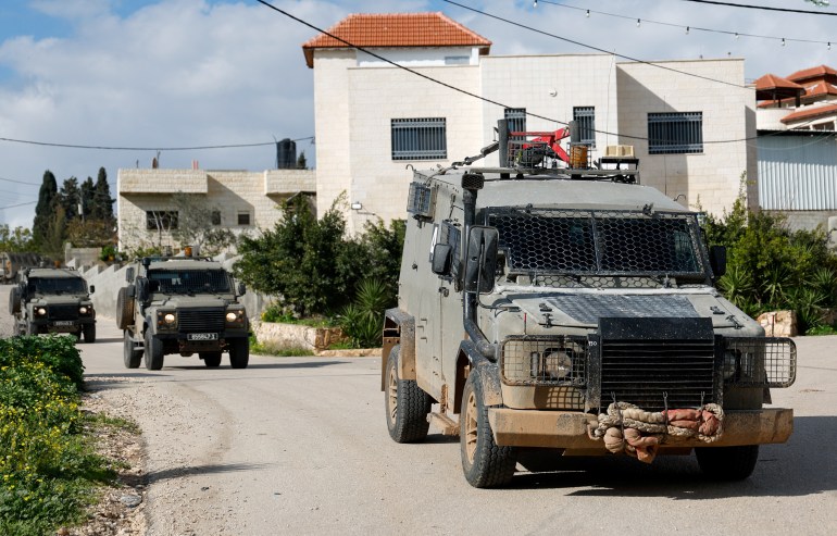 Military vehicles drive amid an Israeli operation in Sir, near Jenin in the Israeli-occupied West Bank January 4, 2024. REUTERS/Raneen Sawafta