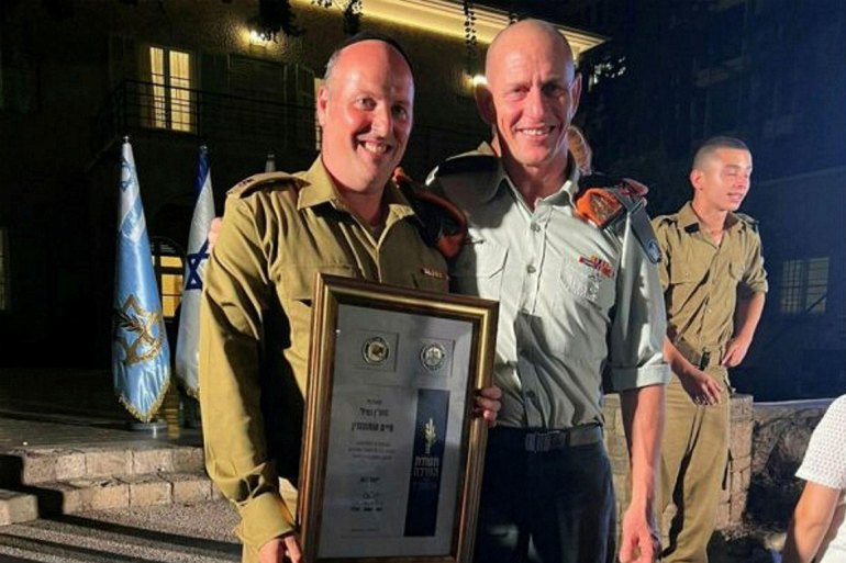 Haim Outmezgine receives a commendation from the IDF in 2022. He says there is an agreement between Zaka and the military allowing it to work.Credit: Zaka