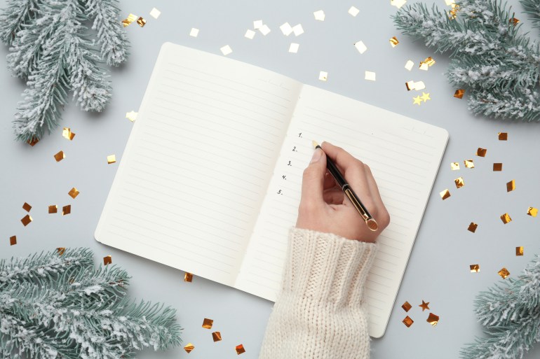Title 2033450030 Category Shutterstock, Shutter Stock, Holidays File Type JPG Image Size 5760 x 3840 Description Woman writing in notebook on light brown table with Christmas decorations, top view.  New Year's Goals Keywords Shutterstock, shutter stock, career, achievement, year, happy, do, resolution, priority, wish, scene, woman, plan, goal, notebook, new, goal, keep, list, christmas, close-up, light, background , person , adult , job , woman , purpose , financial , idea , concept , motivation , inspiration , top , decoration , flat , writing , diet , table , hand , objective , business , change , start , 2022 , health , checklist gray, diary, future, family, strategy